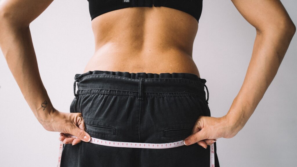 woman shows her body contouring results